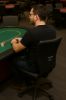 Person sitting in DENZO poker chair at poker table
